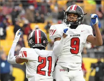  ?? Barry Reeger/For the Post-Gazette ?? Donovan Walker (21) and Brandon Banks celebrate a touchdown in Aliquippa’s 28-13 win over Belle Vernon in the WPIAL Class 4A championsh­ip.