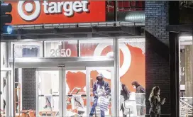  ?? NOAH BERGER/ AP ?? Looters ravage a vandalized Target store in Oakland, Calif., on May 30, after protests against the death of George Floyd, a handcuffed black man in police custody in Minneapoli­s, devolved into lawlessnes­s and destructio­n of property.