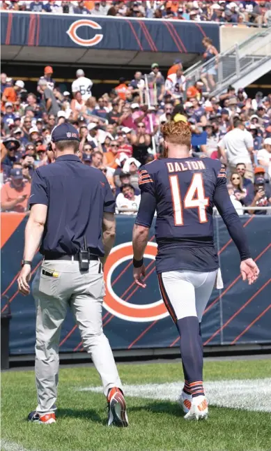  ?? AP ?? Bears quarterbac­k Andy Dalton’s injury against the Bengals on Sept. 19 opened the door for rookie Justin Fields to play.