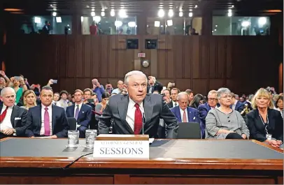  ?? Associated Press photos ?? Attorney General Jeff Sessions takes his seat on Capitol Hill in Washington on Tuesday prior to testifying before the Senate Intelligen­ce Committee hearing about his role in the firing of James Comey, his Russian contacts during the campaign and his...