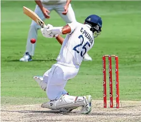  ?? AP ?? Indian batsman Cheteswhar Pujara takes a blow on the helmet batting against Australia on the final day of the fourth test in Brisbane.