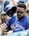  ?? Associated Press ?? Texas Rangers’ Prince Fielder is greeted after scoring on an RBIsingle against the Chicago Cubs July 17 in Chicago.