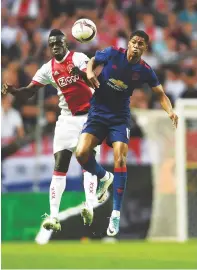  ??  ?? Handful...Marcus Rashford (right) challenges Ajax’s Davinson Sanchez