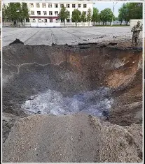  ?? ?? BLAST Crater at the camp after deadly Russian air strikes