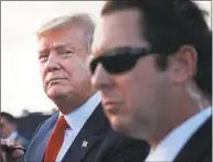  ?? Pablo Martinez Monsivais / Associated Press ?? President Donald Trump looks across the tarmac as he greets supporters upon his arrival at Palm Beach Internatio­nal Airport on Thursday in West Palm Beach, Fla. Trump traveled to Florida to spend the Easter weekend at his Mar-a-Lago estate.