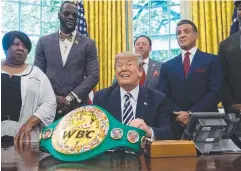  ?? Picture: AFP ?? JUSTICE DONE: US President Donald Trump with Linda Haywood, great-great niece of Jack Johnson, world champion boxer Deontay Wilder and actor Sylvester Stallone yesterday.