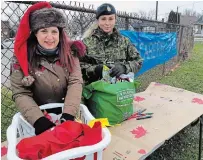  ?? GORD HOWARD TORSTAR ?? Lea Bowman, left, and her daughter Lauren, a reservist with the Lincoln and Welland Regiment 56th Field Regiment, sort through some of the items donated to be shipped to Canadian service members in Latvia.