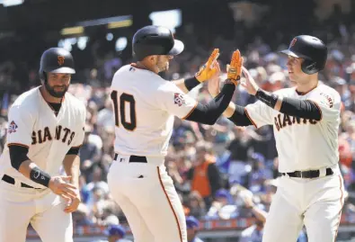  ?? Marcio Jose Sanchez / Associated Press ?? Evan Longoria (10) is met at home plate by Brandon Belt (left) and Buster Posey after his long ball in the first inning.