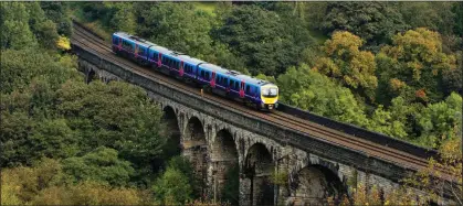  ?? ?? ALL ABOARD: A First Trans-Pennine Express train travelling across the Saddlewort­h Viaduct in Uppermill, Lancashire