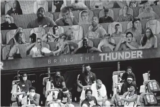  ?? [ASHLEY LANDIS/POOL PHOTO VIA USA TODAY SPORTS] ?? Fans are shown on a video board behind the Utah Jazz bench during the Oklahoma City Thunder's 110-94 win Saturday in Lake Buena Vista, Fla.