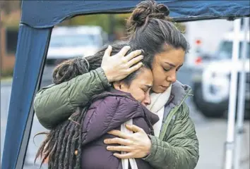  ?? Andrew Rush/Post-Gazette ?? Rachel Gross, right, of Squirrel Hill hugs her sister, Kohenet Keshira haLev Fife, at Thursday’s memorial for the victims of the mass shooting at Tree of Life synagogue. The sisters grew up attending Tree of Life.