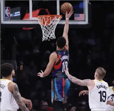  ?? MARY ALTAFFER — THE ASSOCIATED PRESS ?? Nets guard Ben Simmons splits Jazz defenders and goes to the basket during the second half of Monday’s game in Brooklyn.