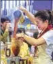  ?? YIN GANG / XINHUA ?? Hong Kong-style milk tea sells well at the First China Internatio­nal Import Expo in Shanghai in November.