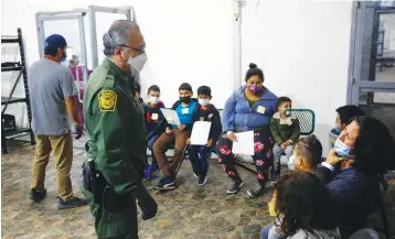  ?? Associated Press ?? ■ Migrants are processed Tuesday at the intake area of the U.S. Customs and Border Protection facility, the main detention center for unaccompan­ied children in the Rio Grande Valley in Donna, Texas.