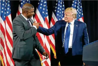  ?? CURTIS COMPTON / CCOMPTON@AJC.COM ?? Paul Morrow, the owner of a concrete business, is welcomed on the stage by President Donald Trump during the Black Voices for Trump Coalition rollout on Friday at the Georgia World Congress Center in Atlanta.