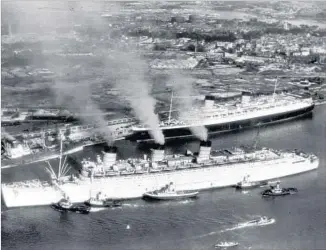  ?? Associated Press ?? THE QUEEN MARY passes its sister ship the Queen Elizabeth in Southampto­n, England, in 1946.