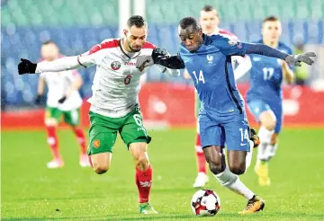  ??  ?? Bulgaria’s midfielder Simeon Slavchev (L) fights for the ball with France’s midfielder Blaise Matuidi during the FIFA World Cup 2018 qualifying football match between Bulgaria and France at The Vasil Levski Stadium in Sofia on October 7, 2017. - AFP...