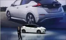  ?? EUGENE HOSHIKO, THE ASSOCIATED PRESS ?? Nissan president and CEO Hiroto Saikawa unveils the new Leaf electric vehicle in China on Wednesday.