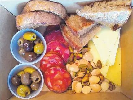  ?? RICHARD S. DARGAN/FOR THE JOURNAL ?? The takeout version of Vara’s tapas board includes chorizo, manchego cheese, olives and nuts.