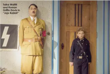  ??  ?? Taika Waititi and Roman Griffin Davis in “Jojo Rabbit”