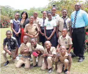  ?? PHOTO BY AMITABH SHARMA ?? Eleanor Nelson, Peace Corps volunteer (second left), and Clovis Menzie, principal of Newstead Primary School, St Mary (right), with some of their students