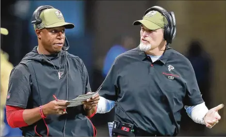  ?? PHOTOS BY CURTIS COMPTON / CCOMPTON@AJC.COM ?? After starting the season 1-7, Falcons coach Dan Quinn (right) switched receivers coach Raheem Morris to defense, and the team went 6-2. The pass rush and coverage improved dramatical­ly, which allowed the offense to stay in games.