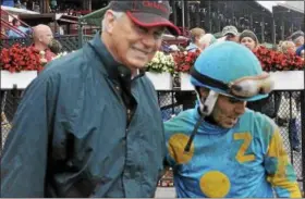  ??  ?? Left: Hall of Fame trainer D. Wayne Lukas, left, smiles next to bug jockey Luis Reyes in the winner’s circle after longshot Perplexed won Race 1 Monday on a muddy main track at Saratoga Race Course. Perplexed paid $232.50 to win. Right: Champagne Ruby...