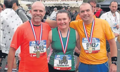  ??  ?? From left: Rob Hoey, Caroline Ness and Neil Hoey at the Amsterdam marathon.