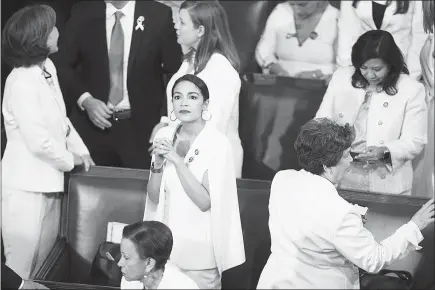  ?? SARAH SILBIGER / THE NEW YORK TIMES ?? Rep. Alexandria Ocasio-cortez, D-N.Y., stands in the House Chamber prior to Trump’s State of the Union address. Attacking socialsim could provide Trump with a potentiall­y effective weapon in confrontin­g an increasing­ly aggressive and more liberal Democratic Party, defining it through attacks on Sen. Bernie Sanders of Vermont and Ocasio-cortez, who describe themselves as democratic socialists, and other members of the party pushing progressiv­e policies.