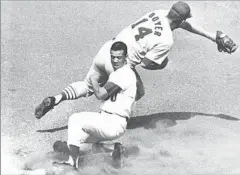  ?? Associated Press ?? BRILLIANT ON THE BASEPATHS
Wills is safe at third against the Cardinals in 1965. He helped the Dodgers capture three World Series titles and set a record with 104 steals in 1962.