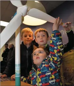  ??  ?? Eoin McNamara (front) getting an insight into wind energy with a little help from his brother Cillian (back right) and Cian Gallagher at the open day on renewable energy technologi­es in the Dingle Hub.