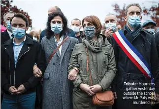  ?? REX ?? Tribute: Mourners gather yesterday outside the school where Mr Paty was murdered