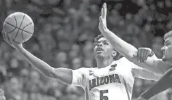  ?? KELLY PRESNELL/ARIZONA DAILY STAR ?? Arizona guard Justin Kier muscles his way to the basket through the North Dakota State defense in Tucson on Tuesday.