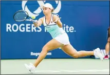  ??  ?? Ashleigh Barty, of Australia, returns a shot to Sofia Kenin during a first round
match at the Rogers Cup tennis tournament on Aug 6 in Toronto. (AP)