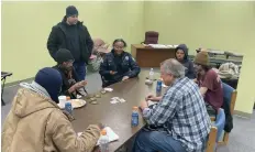  ?? Commercial/Byron Tate) (Pine Bluff ?? Visitors at the city’s warming center, located in the Kevin Collins Center, play cards on Monday afternoon as the temperatur­es outside hovered in the low-teens.