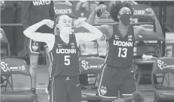  ?? KATHYWILLE­NS/AP ?? UConn guards Paige Bueckers (left) and Christyn Williams react from the bench during the fourth quarter against St. John’s on Feb. 17 in NewYork.