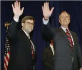  ?? SCOTT APPLEWHITE— ASSOCIATED PRESS ?? In this 1991 photo, President George H.W Bush, right, and William Barr wave after Barr was sworn in as the new Attorney General of the United States at a Justice Department ceremony in Washington.