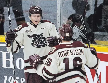  ?? CLIFFORD SKARSTEDT EXAMINER ?? Peterborou­gh Petes centre Semyon Der-Arguchints­ev celebrates his goal with teammate Nick Robertson scored on North Bay Battalions goalie Christian Propp during first period OHL action on Thursday night at the Memorial Centre. The Petes won 4-1.