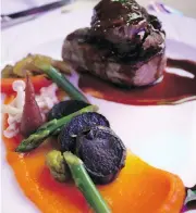  ?? ANDREA CHAN ?? Alberta Pork tenderloin medallions and braised cheek with pickled vegetables served at the gala dinner.