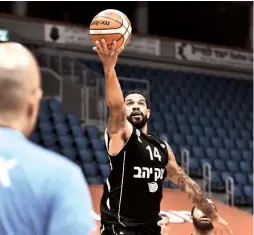  ?? (Dov Halickman Photograph­y) ?? HAPOEL JERUSALEM guard James Feldeine goes to the hoop for two of his 13 points in the Reds’ 84-78 victory over Maccabi Rishon Lezion at the capital’s Pais Arena in both teams’ first Winner League game back after a long layoff.