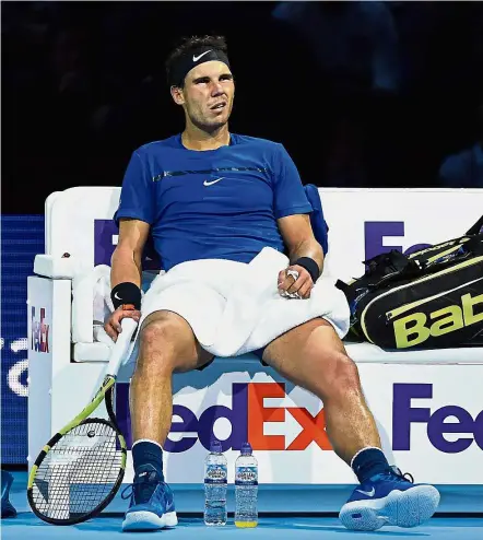  ??  ?? Game over: A tired-looking Rafael Nadal during a break between games in his match against David Goffin at the ATP Finals in London on Monday. — AFP