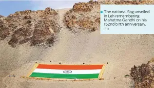  ?? PTI ?? The national flag unveiled in Leh rememberin­g Mahatma Gandhi on his 152nd birth anniversar­y.