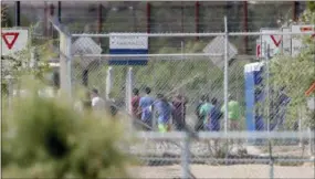  ?? THE ASSOCIATED PRESS ?? Detainees are seen inside a facility, where tent shelters are being used to house separated family members at the Port of Entry in Fabens, Texas.