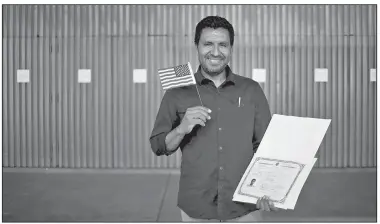  ?? The New York Times/JENNA SCHOENEFEL­D ?? Yonis Bernal holds his naturaliza­tion certificat­e in Los Angeles on Oct. 17. The number of citizenshi­p applicatio­ns continues to rise as immigratio­n rhetoric and policy toughen.