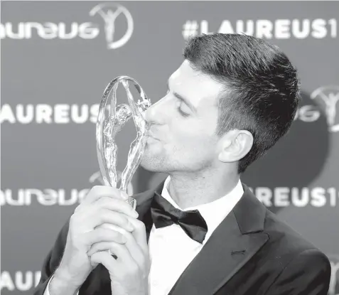  ?? AGENCE FRANCE PRESSE ?? Laureus World Sportsman of The Year 2019 winner Serbia’s tennis player Novak Djokovic poses with his award at the 2019 Laureus World Sports Awards ceremony at the Sporting Monte-Carlo complex in Monaco.