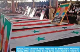  ??  ?? SWEIDA, Syria: A handout picture released by the official Syrian Arab News Agency (SANA) shows coffins lined up during a mass funeral of yesterday’s suicide attacks victims in the southern city of Sweida. — AFP