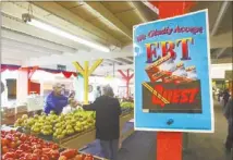  ?? ASSOCIATED PRESS (2010) ?? A sign announces the acceptance of Electronic Benefit Transfer cards at a farmers market in Roseville, Calif. A bill in the House would cut more than $20.5 billion to the federal food stamp program.