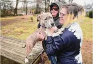  ?? ?? Siblings Adam and Samantha Reichardt, of
Seymour, look to adopt 3-year-old pit bull Miss Basil