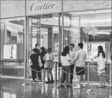  ?? WANG GANG / FOR CHINA DAILY ?? Consumers line at a Cartier store in Shanghai in September.