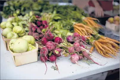  ?? MONICA JORGE/HARTFORD COURANT ?? Produce is sold at the North End Farmers Market in Middletown in 2017. Buying locally grown produce is generally better for the environmen­t.